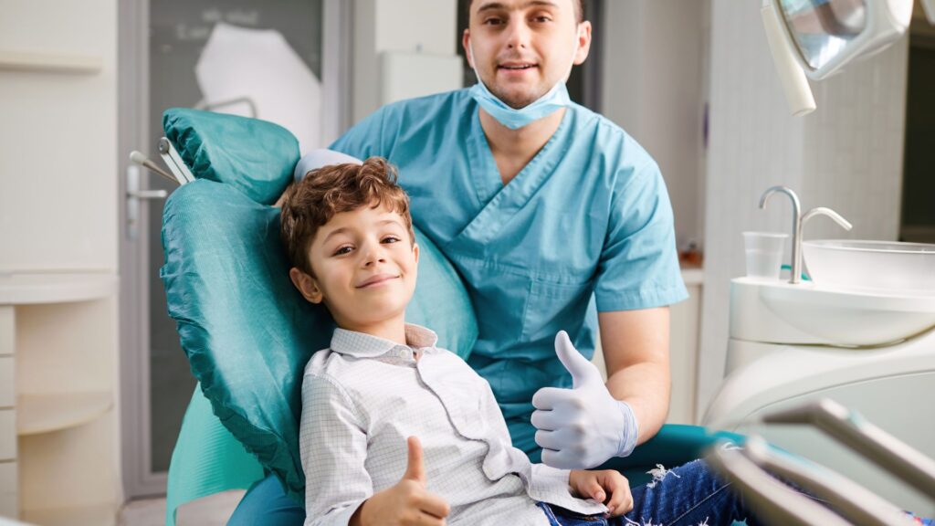 A dentist and his child giving a thumbs up at a family dental clinic in Wellawatte.