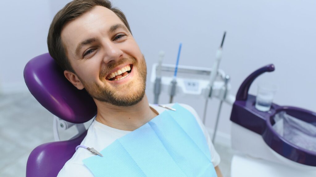 A man smiling in a dental clinic