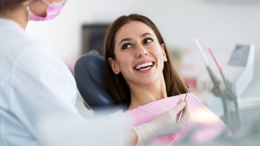 A woman smiling at her dentist at a family dental clinic in Wellawatte.